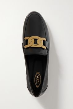 Tod's loafers are a classic style that'll work with everything from cropped jeans to dresses and tailoring. They're made from smooth leather and topped with an oversized gold chain. Luxury Calf Leather Loafers For Work, Black Calf Leather Loafers With Metal Feet, Elegant Slip-on Loafers With Branded Heel Counter, Formal Leather Loafers With Metal Logo, Elegant Leather Loafers With Metal Logo, Elegant Calf Leather Loafers For Business Casual, Chic Business Casual Loafers, Luxury Black Loafers With Metal Details, Luxury Black Loafers With Metal Feet