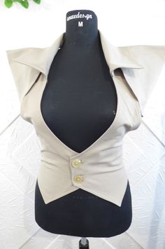 Stylish women's vest in beige color with additional parts.  The model can be made in other colors. Available sizes - IZE-EU-XXS-34 Bust-78cm.-80cm. Waist-58cm.-62cm. Hips - 84cm.-88cm. SIZE-USA-0 Bust -30.50in.-31in. Waist- 22.50in.-24in. Hips-33in.-34.50in. --------------------------------------------------- ------------------------------------ SIZE-EU-XS-36 Bust-81cm.-85cm. Waist-64cm.-67cm. Hips -88cm.-91cm. SIZE-USA-2 Bust-32in.-33.50in. Waist -25in.-26in. Hips-34.50in.-35.50in --------------------------------------------------- -------------------------------- SIZE-EU-S-37-38 Bust - 85cm.-89cm. Waist - 67cm.-71cm. Hips-91cm.-95cm. SIZE-USA-4 Bust -33in.-35in. Waist-26in.-28in. Hips-35.50in.-37.50in. --------------------------------------------------- ---------------------------------- Steampunk Vest Women, Chic Stretch Beige Vest, Chic Beige Stretch Vest, Fitted Beige Vest Outerwear, Fitted Khaki Vest For Work, Beige Fitted Vest Outerwear, Fitted Beige Summer Outerwear, Fitted Beige Outerwear For Summer, Taupe Fitted Sleeveless Top