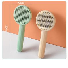 two green and white hair brushes sitting next to each other