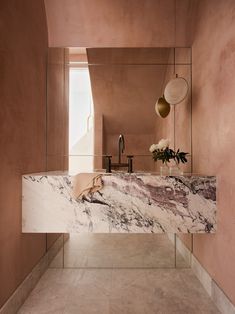 a bathroom with marble counter tops and walls