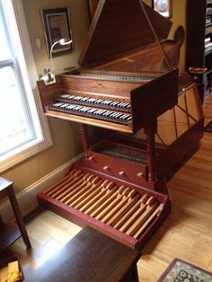 a grand piano sitting on top of a hard wood floor