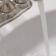 a faucet that is pouring water into a sink