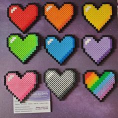 pixel heart magnets are displayed on a purple surface with a price tag in the foreground