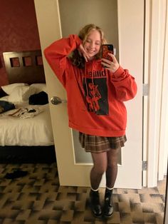 a woman taking a selfie in a hotel room with her phone up to her ear