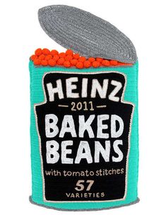 a can filled with baked beans sitting on top of a table