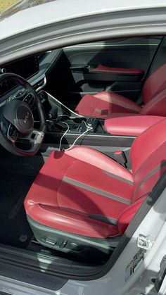 the interior of a car with red leather seats