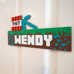 a wooden sign that says kentucky on the side of a door with a pixel design