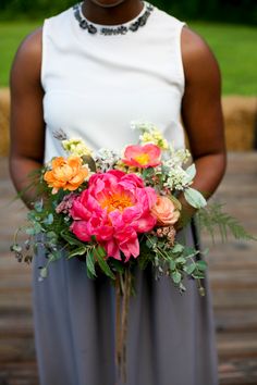 a woman holding a bouquet of flowers in her hands