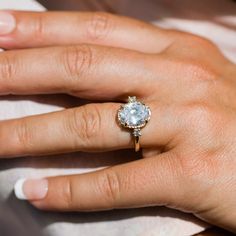 a woman's hand with a diamond ring on it