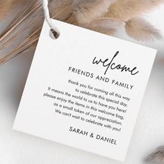 a welcome card with the words friends and family written on it next to some feathers