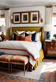 a bedroom with a bed, dresser and pictures on the wall above it's headboard