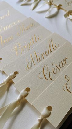 the wedding stationery is laid out on top of each other with ribbons and bows