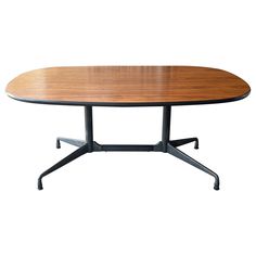 an oval wooden table with metal legs and a black frame on the top, against a white background