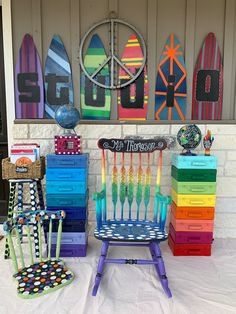 colorful chairs and surfboards are on display in front of a wall with the word surf painted on it