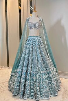 The Camellia Lehenga set is Turkish blue taffeta , heavily embroidered Lehenga set. The Dupatta is a beautiful net embroidered dupatta. DELIVERY TIMEPlease allow 8-12 weeks for your outfit to arrive. FABRIC DETAILSSilk Taffta top and lehenga Soft Net Dupatta Professional cleaning only. Lehenga Choli Online Shopping India, Desi Bridal Lehenga, Types Of Lengha, New Lengha Design, Aesthetic Lengha, Aesthetic Lehengas, Lehenga For Garba, Wedding Outfit Ideas For Women, Indian Wedding Lehenga Bridal