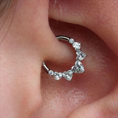 a close up view of a person's nose with an ear piercing in the shape of a crescent