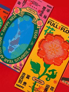 three different colored flyers with chinese writing on red paper and one has an image of a flower in the middle