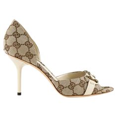 The Gucci pumps are coated in the most popular beige/ebony GG fabric and trimmed in ebony leather trim, thus its neutral style makes it classic for years to come and versatile to go along with most your outfits in the closet. It would be just a very simple and ordinary pump if not for the light gold horsebit at front which greatly accents up the sumptuousness as well as sophistication of the whole design and completes the timeless design of this pair. Gucci GG Horsebit D'Orsay Peep-toe Pump, Bei Chic High Heels, Heels Gucci, Gucci Pumps, Gucci Baby, Gucci Heels, Africa Dress, Shoe Ideas, Kawaii Shoes, Beige Heels