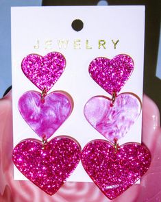 I searched high and low to find the most beautiful, sparkling pink heart earrings. They are made from acrylic, glitter and pearlessence pink colors. Hypoallergetic posts. You won't find a more beautiful pair. Pink Resin Heart Earrings For Gift, Pink Resin Heart Earrings As Gift, Pink Heart Beads Jewelry For Party, Pink Heart Resin Earrings, Cute Resin Heart Earrings For Valentine's Day, Trendy Valentine's Day Party Earrings, Pink Heart Charm Jewelry For Party, Pink Heart Earrings For Party, Pink Drop Earrings For Valentine's Day