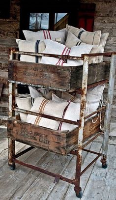 an old wooden crate filled with lots of pillows