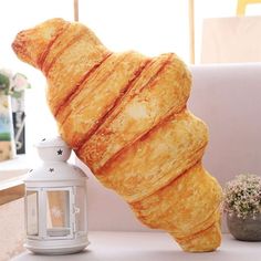 a large croissant sitting on top of a white table