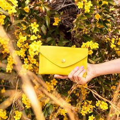 Lemon YellowTHE wallet. Functions like a dream, holds all you need, doubles as a clutch. Available in a myriad of colorful leather options, so you can choose the one that is perfectly you. This classic design features 6 credit card slots, a compartment for organizing bills and receipts, and a back zippered coin pocket— all in a slender silhouette. The sleeve of this wallet also holds your phone, so feel free to carry it solo anytime you feel like getting dressed up. Available in soft chrome tann Envelope Coin Purse For Everyday Use, Everyday Trifold Clutch With Card Slots, Everyday Envelope Card Holder, Modern Envelope Wallet With Removable Pouch, Trendy Yellow Wallet For Everyday Use, Trendy Yellow Wallets For Everyday Use, Trendy Bifold Clutch For Everyday Use, Trendy Everyday Bifold Clutch, Yellow Coin Purse For Everyday Use