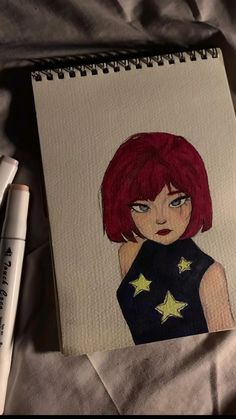 a drawing of a girl with red hair and stars on her shirt next to two markers