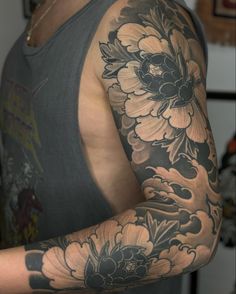 a man with a flower tattoo on his arm