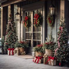 christmas trees are lined up on the porch