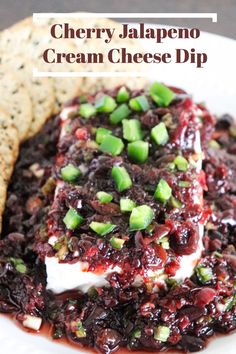 cranberry jalapeno cream cheese dip with crackers on the side