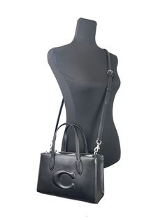 Style: Coach (CR097) Nina Small Tote Crossbody Bag (Black) Material: Leather Features: Adjustable Crossbody Strap, Zip Closure, Fabric Lined Measures: 10" L x 6.5" H x 4" D Coach Medium Leather Shoulder Bag, Medium Satchel With Top Carry Handle, Luxury Medium Shoulder Bag For Evening, Medium Satchel With Detachable Handle, Chic Evening Medium Bag, Chic Medium Evening Bags, Medium Evening Bags, Elegant Medium Black Bag, Elegant Black Medium-sized Bag