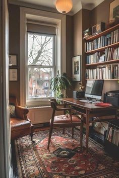 a room with a desk, chair and bookshelf full of books in it