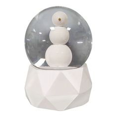 a snowman in a glass ball on top of a white base