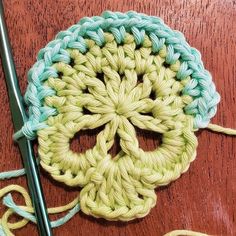 a crocheted skull is sitting on a table next to yarn