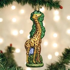 a giraffe ornament hanging from a christmas tree