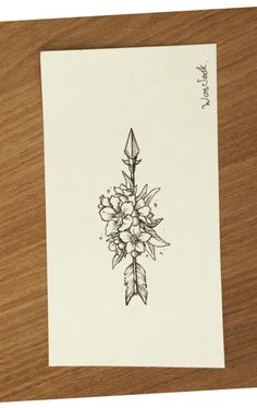 a drawing of flowers and an arrow on a piece of paper