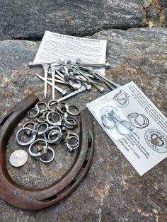 a bunch of scissors and other metal items on a rock