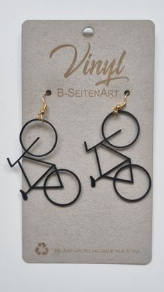 pair of black and gold earrings with the word'b - stenart'written on it