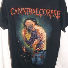 New/Unworn - Cannibal Corpse T-Shirt - Size Small. 2019 The Decibel Magazine Tour Print. Standard Unisex Crew Neck, Short Sleeve T-Shirt With Graphic Print Front And Back. Gildan Heavy Cotton 100% Cotton. Horror Graphic Print Top For Alternative Fashion, Black Horror Tops For Alternative Fashion, Graffiti Print Top For Halloween Concert, Graffiti Print Tops For Halloween Concert, Black Band Merch Shirt For Concert, Alternative Style Black Shirt For Fan Merchandise, Halloween Concert Band Merch Tops, Black Deadstock T-shirt For Halloween, Alternative Style Graffiti Print Top For Fan Merchandise