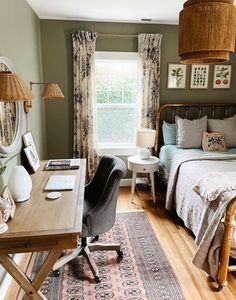 a bed room with a neatly made bed next to a desk and chair in front of a window