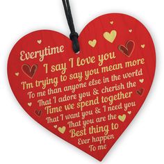 a red heart shaped hanging decoration with the words, i say i love you more