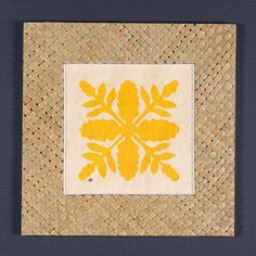 a woven piece with yellow flowers on it