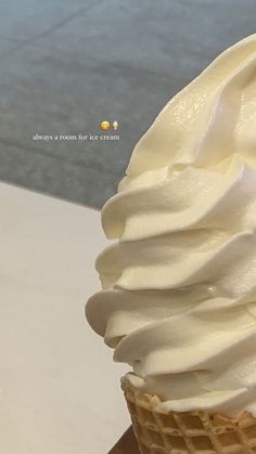 an ice cream cone with whipped cream on top