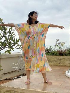 This is our "Timeless" style kaftan. It features a drawstring that you can cinch at the waist. This loose fitting Caftan House dress is exceptionally comfortable and stylish.As for the fabric pattern, we have used a hand drawn and digitally painted technique. So they are all unique designs. It is like wearing wearable art. What I love about digital paintings is that they look as beautiful as the hand paintings but the care needed for them is much less. You can wash them on a gentle cycle and han Summer Beach Maxi Dress With Drawstring, Bohemian Beach Dress With Drawstring, Casual Beach Dress With Drawstring For Cover-up, Flowy Drawstring Dress For Vacation, Spring Beach Cover-up Kaftan With Tie Waist, Spring Beachwear Kaftan With Tie Waist, Spring Vacation Kaftan With Tie Waist, Beach Season Drawstring Dress Cover-up, Casual Beach Maxi Dress With Drawstring