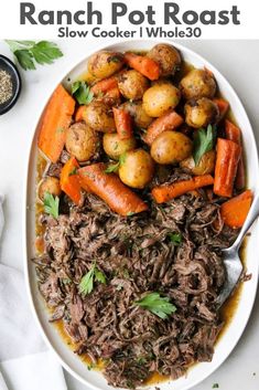 a white plate topped with roast, potatoes and carrots on top of a table