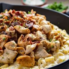 chicken and bacon pasta in a skillet ready to be eaten