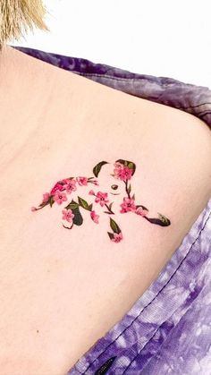 a woman's lower back tattoo with pink flowers