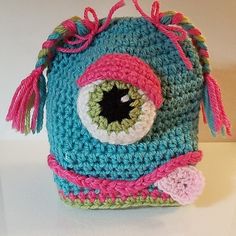 a crocheted bag with an eyeball on it