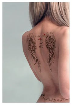 the back of a woman's body with tattoos on it