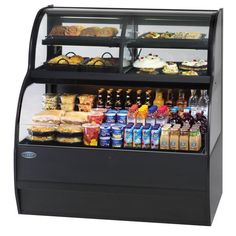 the deli display case is full of food and drinks, including breads, pastries